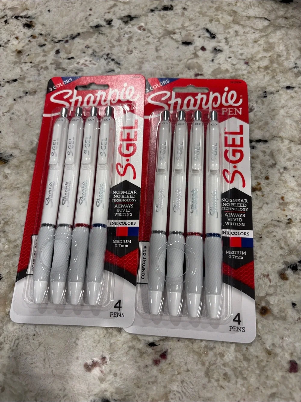 Brand new never opened packs of sharpie pens. Two black, a red & blue in each.